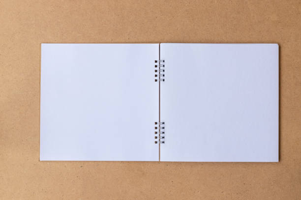 istock Top view of notebook open white page for diary writing, school education concept. 1250137131