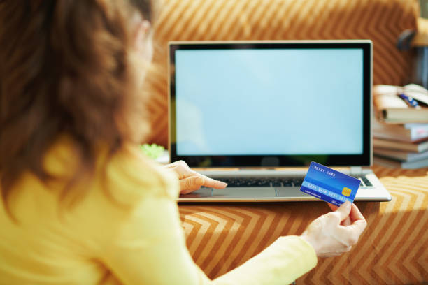 istock female with credit card and laptop blank screen 1250138105