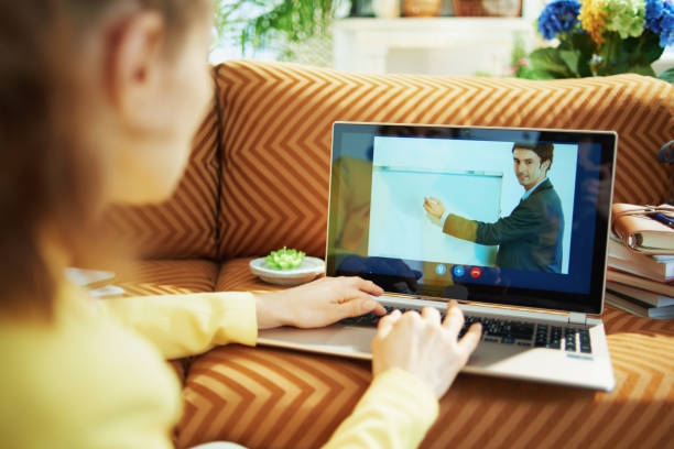 istock trendy woman study online with teacher using video call 1250138154