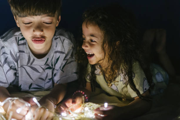 istock Smiling kids playing with lights at camp 1250139727