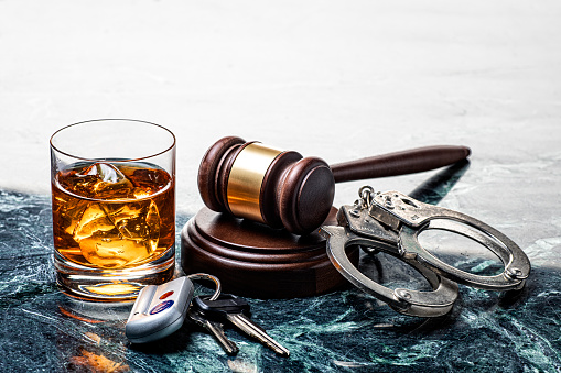 Drinking and Driving Handcuffs and Gavel on Marble Background