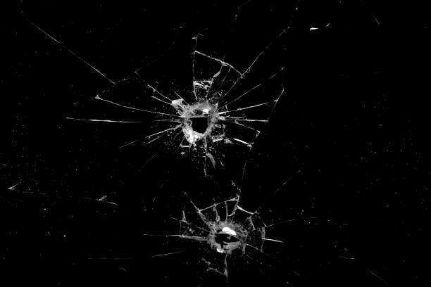 istock holes in the glass with cracks isolated on a black 1250143947