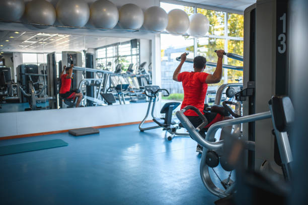 istock Mid Adult African Man Using Shoulder Press at Gym 1250143969