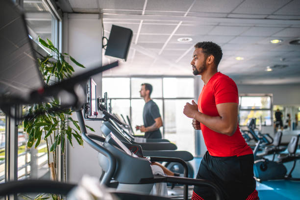 istock Mid Adult Men Using Treadmills at Gym 1250143972
