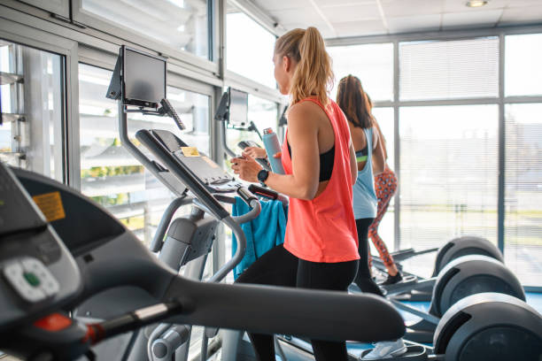 istock Dedicated Young Fitness Enthusiasts Using Cross Trainers 1250143976