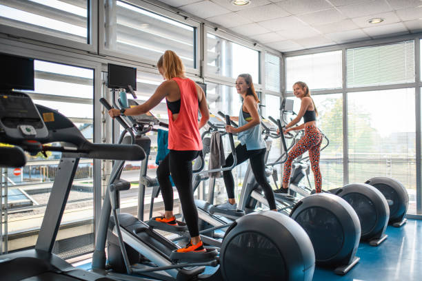 istock Female Friends Enjoying Elliptical Workout at Gym 1250143980