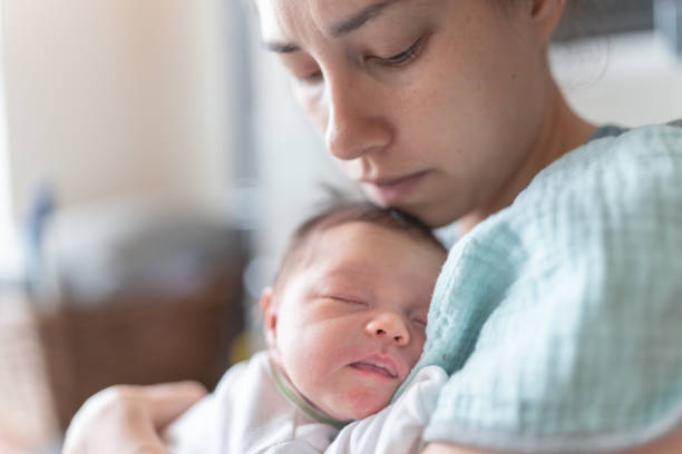 istock New mom snuggles her newborn daughter 1250144050