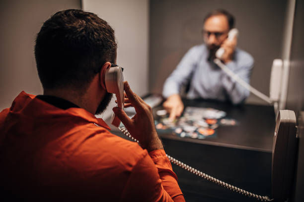 istock Inmate talking with detective in prison visit room 1250149413