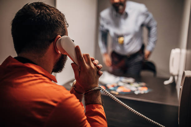 istock Inmate talking with detective in prison visit room 1250149459