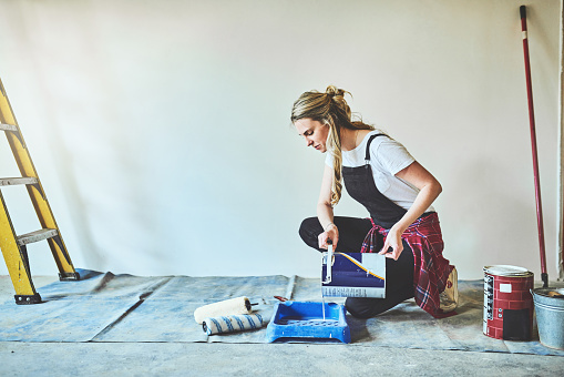 Shot of a young woman getting ready to paint the walls at home