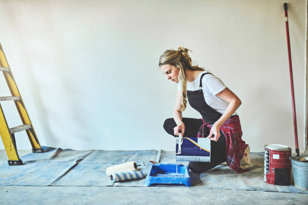 Only the best paint will do Shot of a young woman getting ready to paint the walls at home resourceful stock pictures, royalty-free photos & images