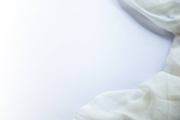 istock Blank white table for copy space with a piece of white fabric on the right side. 1250151655