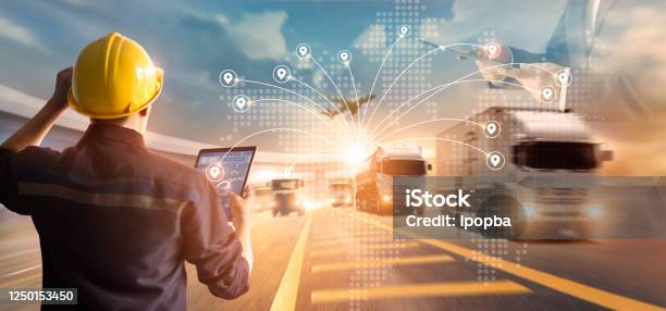 Transport And Logistic Concept Manager And Engineer Checking And Controlling Logistic Network Distribution And Data On Tablet For Logistic Import Export On Motorway Background Stock Photo - Download Image Now