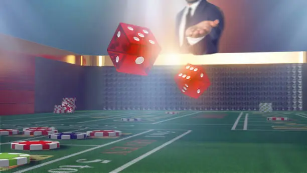 Close-up rolling dice on a craps table in casino. Man throwing dice on craps table.