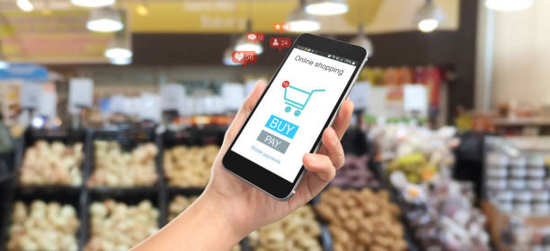 istock Man hand holding smartphone device and touching screen. Online shopping 1250154702