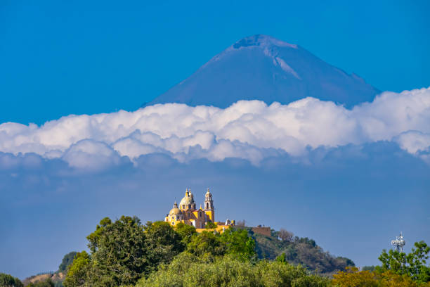 Colorful Yellow Our Lady of Remedies Church Volcano Popocatepetl Cholula Mexico Colorful Yellow Iglesia de Nuestra Senora de los Remedios Our Lady of Remedies Church Volcano Mt, Popocatepetl Cholula Puebla Mexico. Church built 1500s popocatepetl volcano photos stock pictures, royalty-free photos & images