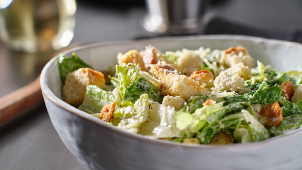 istock fresh caesar salad with croutons and parmesan cheese in bowl 1250161567