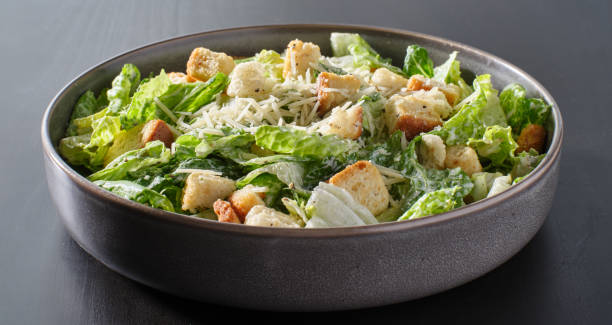 istock fresh caesar salad with croutons and parmesan cheese in bowl 1250161573