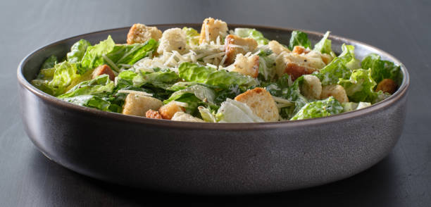 istock fresh caesar salad with croutons and parmesan cheese in bowl 1250162091