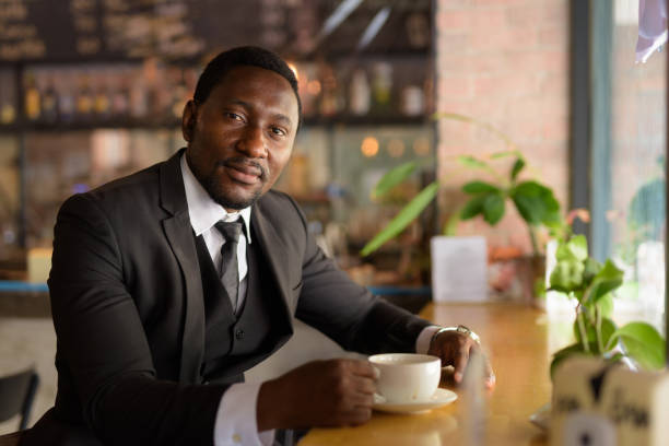 istock Handsome bearded African businessman relaxing inside the coffee shop 1250165109