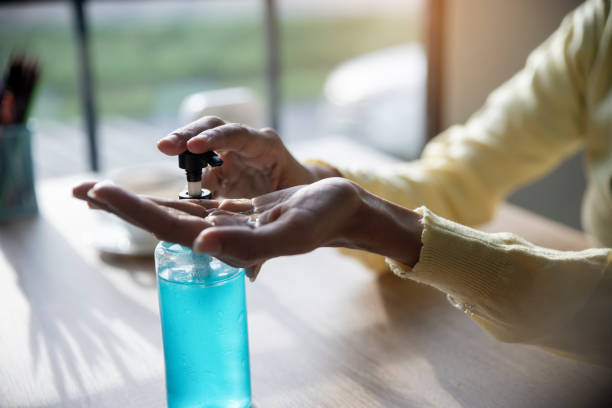 istock Female washes and clean hands with alcohol gel 1250168585