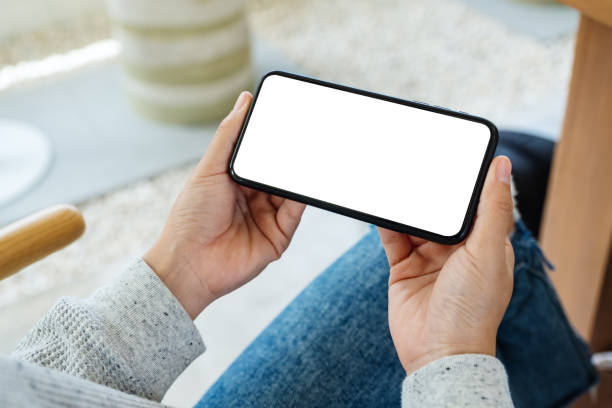 istock a woman holding mobile phone with blank white desktop screen 1250168660
