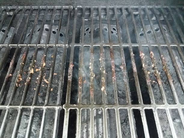 istock dirty or filthy bars on barbecue grill wih smoke 1250169730