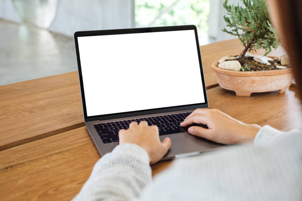 istock a woman using and typing on laptop computer with blank white desktop screen on wooden table 1250170465