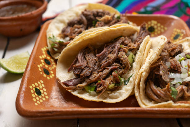 istock Mexican slow cooked lamb tacos also called barbacoa on white background 1250173908