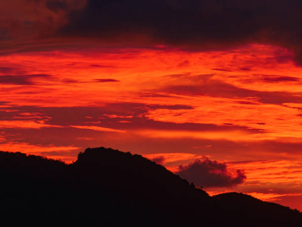 istock Twilight beautiful evening cloudy sky  after sunset background . There are silhouette mountains and trees. 1250175742