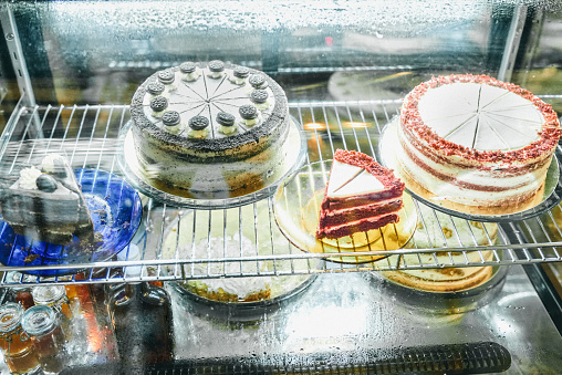 Shot of various cakes in a display case at a restaurant