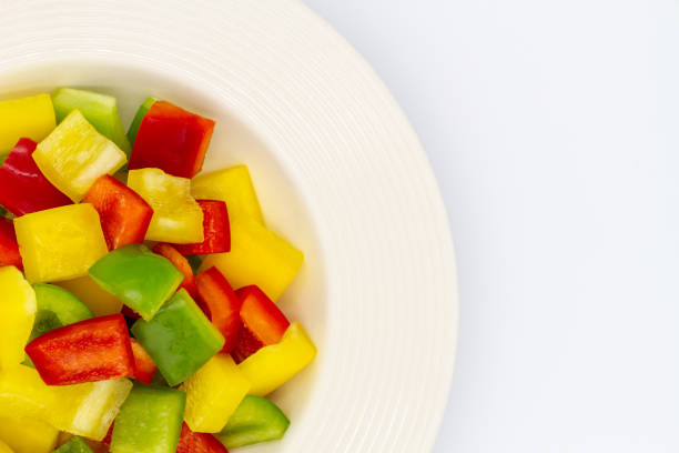 istock Sliced bell pepper on single white ceramic bowl over white background. 1250178092