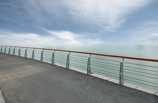 Asphalt with guardrail on the seashore under clear sky