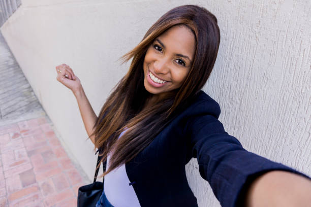 istock Young business woman looking very happy while taking a selfie 1250179641