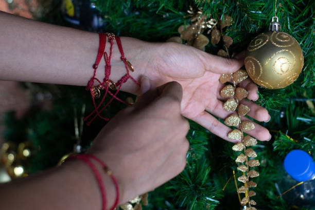 istock woman hand arranging christmas tree 1250181956