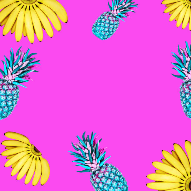 Contemporary collage. Flying bananas and pineapples on a bright pink background. The concept of food, summer.