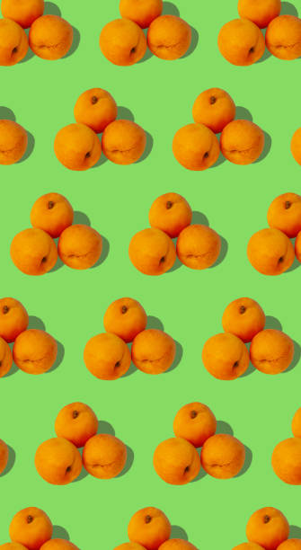 istock Apricot regular pattern with hard shadows flat lay on pastel turquoise background. Creative layout summer fruits. 1250186962