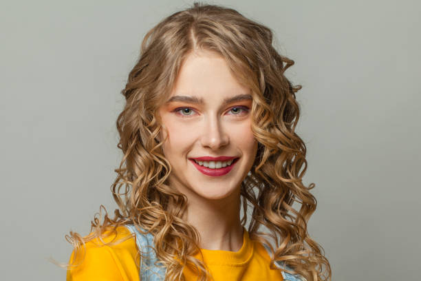 istock Pretty girl smiling on gray background 1250187050