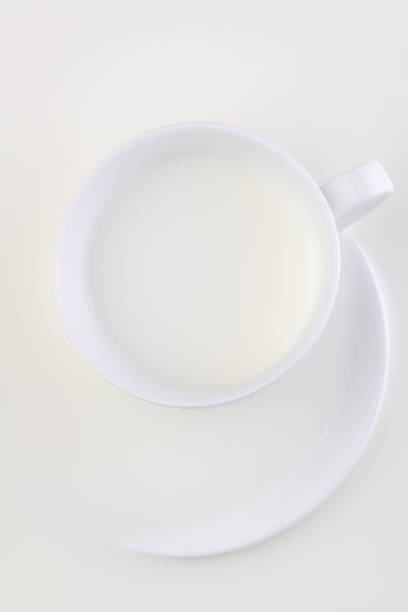 istock White set cup and saucer in a milk bath. 1250189732