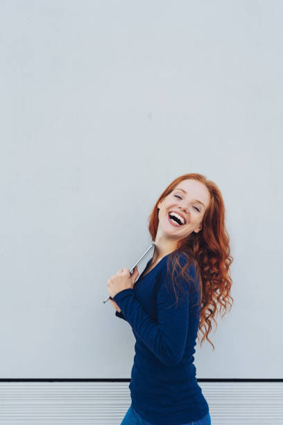 istock Young cheerful woman holding digital tablet 1250189865