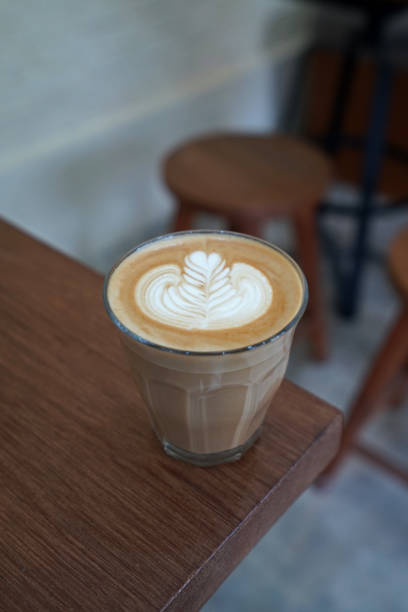 istock A cup of hot Latte coffee left on wooden table 1250190033