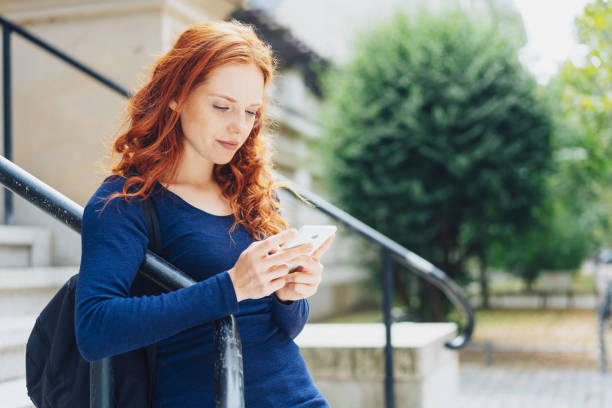 istock Serious young woman reading a text message 1250190356