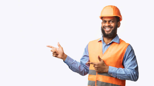 istock Builder Guy In Uniform Pointing Fingers Aside On White Background 1250194255