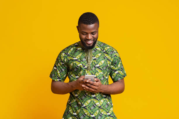 istock Cheerful african man looking at smartphone screen 1250195563