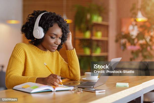 Smiling Black Girl With Headset Studying Online Using Laptop Stock Photo - Download Image Now