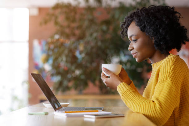 istock Black lady enjoying morning coffee and checking emails 1250195710