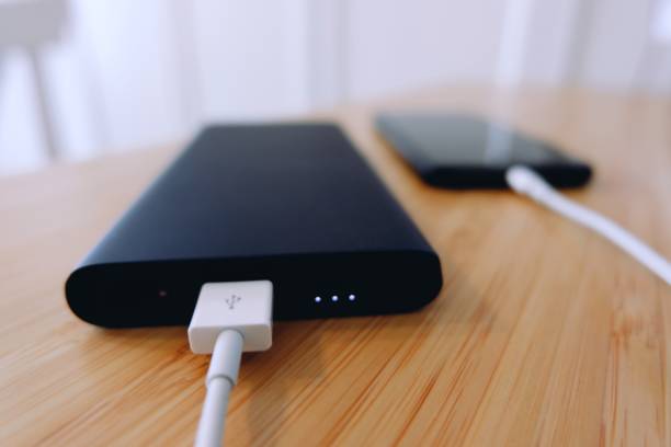 istock Charging a black smartphone with powerbank portable charger 1250196520