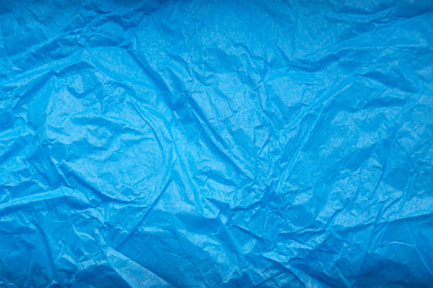 istock Crumpled blue wrapping paper as abstract background, texture 1250198636