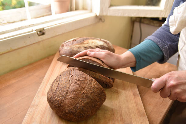 istock Cutting loaf of bread into slices. Homemade bread 1250200251