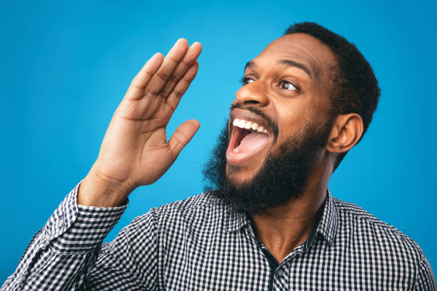 istock Black guy holding hand near mouth, screaming aside 1250202140